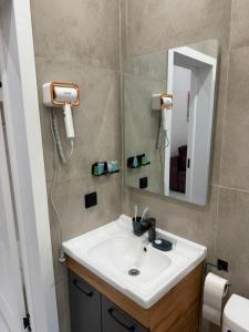 a bathroom with a sink and a mirror at Sherpa space in Almaty +67 photos