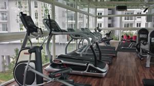 a gym with a bunch of cardio machines at Getaway Residence at Cyberjaya in Cyberjaya