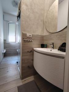 a bathroom with a large tub and a mirror at Villa Graziano in Cesenatico +56 photos