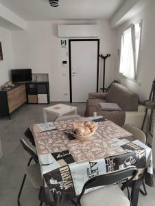 a living room with a table and a couch at La Casa di Mami in Velletri