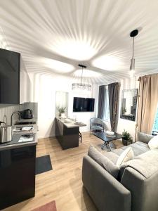 a living room with a couch and a table at Pokład Jurata in Jurata