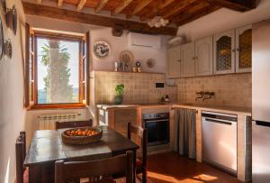 a kitchen with a table with a bowl of fruit on it at Il Casone di Rigomagno in Rigomagno +64 photos