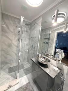 a bathroom with two sinks and a shower at Pokład Jurata in Jurata +14 photos