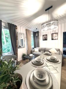 a living room with a table with plates on it at Pokład Jurata in Jurata
