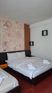 a bedroom with two beds and a painting on the wall at Hotel Sliv Elite Events in Blatec