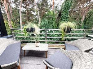 a patio with two chairs and a table at Pokład Jurata in Jurata