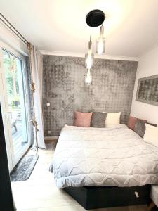 a bedroom with a bed in a room with a window at Pokład Jurata in Jurata