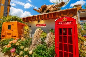 a red phone booth in front of a building at Sweet August · Boutique Hotel (Dali Erhai) in Dali