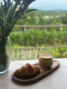 a wooden plate with a cup of coffee and a pastry at Tiny house Pálava in Bořetice