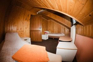 a bedroom with two beds in a room with wooden walls at FELIX hostel in Dumbrăveni