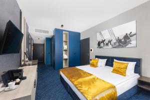 a hotel room with a bed and a tv at LUA Boutique RoomZ- Adults only in Balatonfüred