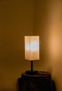 a lamp sitting on top of a wooden table at Villa Palmarcito in El Zonte