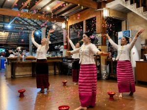 a group of women dancing on a dance floor at Aruna Mountain Lodge in Ban Huai Rin