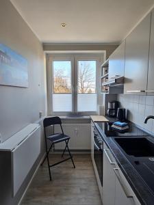 a kitchen with a chair in a small kitchen at Apartment mea in Berlin