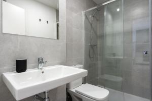 a bathroom with a sink and a toilet and a shower at Live It Malaga in Málaga +30 photos