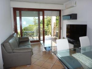 a living room with a couch and a glass table at BlueVille21 in Germignaga