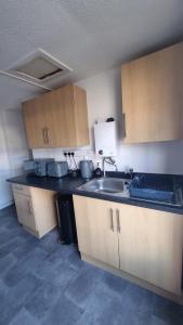 a kitchen with a sink and a counter top at Boho Bliss in Swansea +7 photos