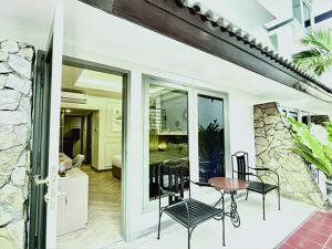 a house with a table and chairs on a patio at Hotel Bisanta Bidakara Tunjungan in Surabaya