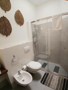 a bathroom with a shower and a toilet and a sink at B&B Colori del Salento in Presicce +52 photos