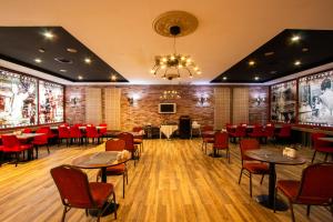 a restaurant with tables and chairs and a brick wall at Maltepe 2000 Hotel in Ankara