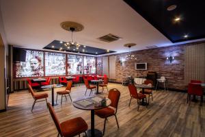 a restaurant with tables and chairs and a brick wall at Maltepe 2000 Hotel in Ankara