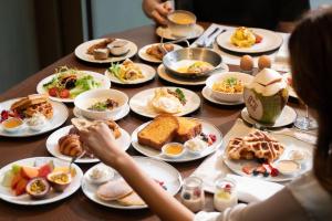 a table full of plates of breakfast food at Dusit Thani Bangkok in Bangkok