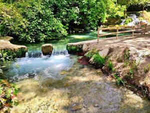 a stream of water with a bench next to a river at Hostal Avenida Pozo Alcón in Pozo Alcón +9 photos