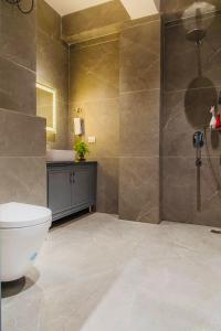 a bathroom with a toilet and a sink and a shower at Dream Haven Kasauli in Kasauli +43 photos