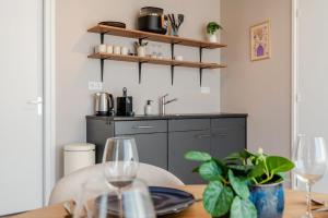 a kitchen with a table with two wine glasses at Boven restaurant de Babbelaar 1 in Oostkapelle +18 photos