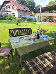 a table with plates of food on it in a yard at Schenkenhof Proitze in Schnega
