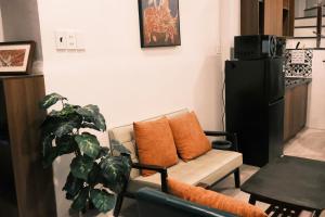 a living room with a couch and a plant at Saigon Holiday House in Ho Chi Minh City