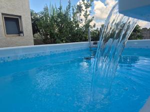 a water fountain in a swimming pool at פינוק של סוויטה in Manot +9 photos
