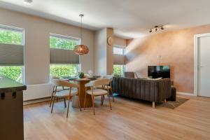 a living room with a table and a couch at Boven restaurant de Babbelaar 2 in Oostkapelle