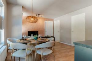 a dining room with a table and four chairs at Boven restaurant de Babbelaar 2 in Oostkapelle +17 photos