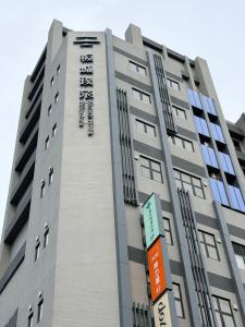 a building with a sign on the side of it at Boutech hotel Banqiao Yellowstone in Taipei
