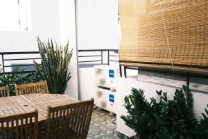 a patio with a table and chairs and plants at Saigon Holiday House in Ho Chi Minh City