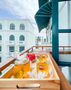 a tray of drinks on a table on a balcony at MARINA SEASIDE BEACH BOUTIQUE Phu Quoc - Infinity Pools - PREMIUM SOLAR ENERGY in Phú Quốc