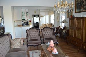 a living room with two chairs and a table at Brahenkatu Apartment in Kajaani +3 photos