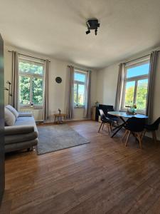a living room with a couch and a table at Plauen-West in Plauen