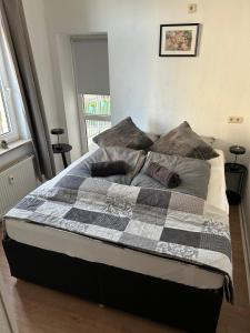 a bed in a bedroom with a checkered blanket at Plauen-West in Plauen