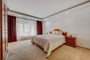 a bedroom with a bed and a large window at Cozy Apartment Floreasca Park in Bucharest +11 photos