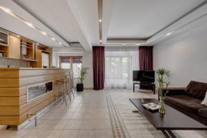a living room with a couch and a table at Cozy Apartment Floreasca Park in Bucharest