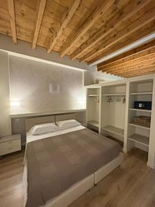 a bedroom with a large bed and wooden ceilings at Corte Trambai in Gambellara