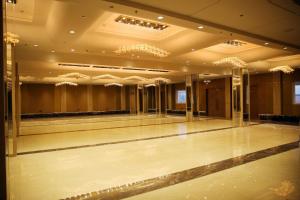 a empty dance floor in a building with chandeliers at Bhola Resort in Soraon