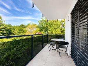 a patio with a table and chairs on a balcony at TO-HAD, Modern Apartments next to U-bahn with free Wifi in Vienna