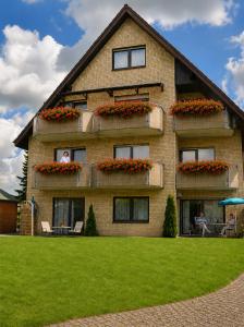 a building with a woman looking out of a window at Gästehaus Stillecke in Erwitte