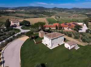 an aerial view of a large white house on a green field at Relais Villa Grazianella | UNA Esperienze in Acquaviva