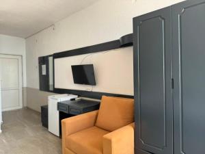 a living room with a couch and a tv at Alevok Hotel in Erdek