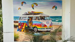 a painting of a van with surfboards on the beach at ZanziBlue Beach Hotel in Mfumbwi