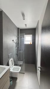 a bathroom with two toilets and a sink and a toilet istg at ZanziBlue Beach Hotel in Mfumbwi